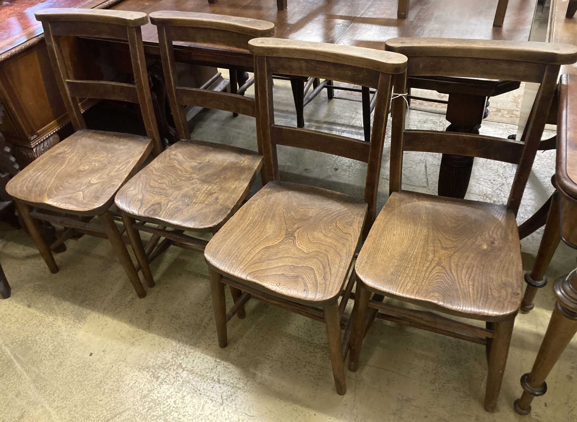 A set of four late Victorian elm and beech chapel chairs.